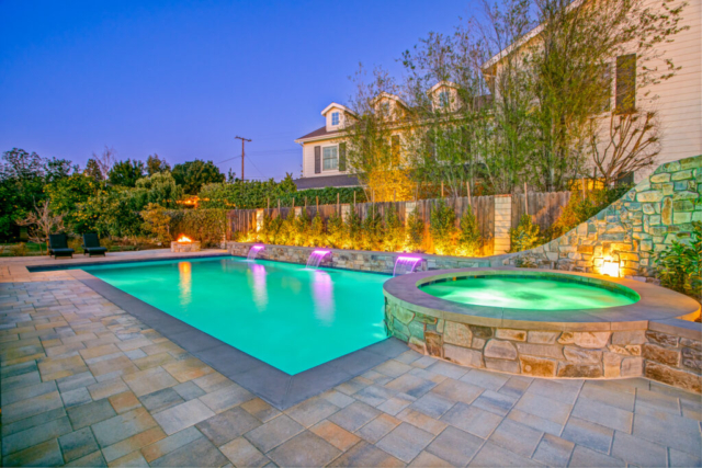Rectangular Pool with Circular Spa, Slide, and Stone